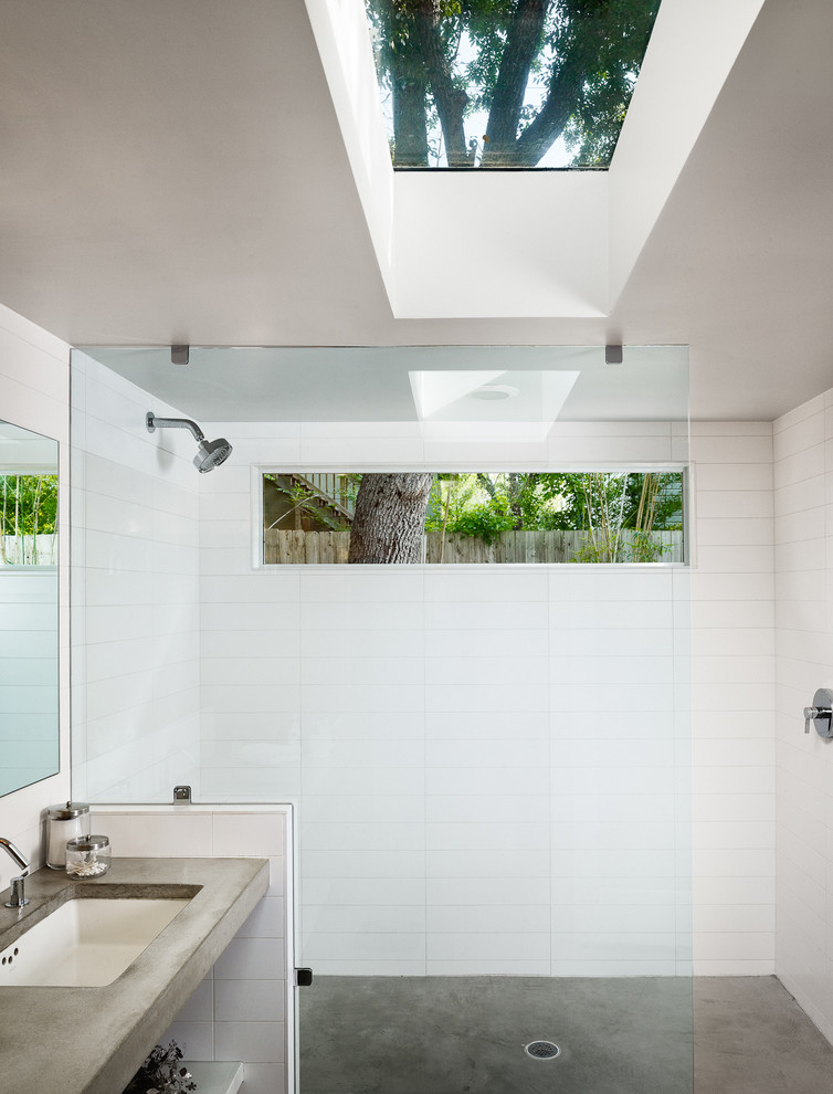 Inspiration for a contemporary concrete floor bathroom remodel in Austin with concrete countertops