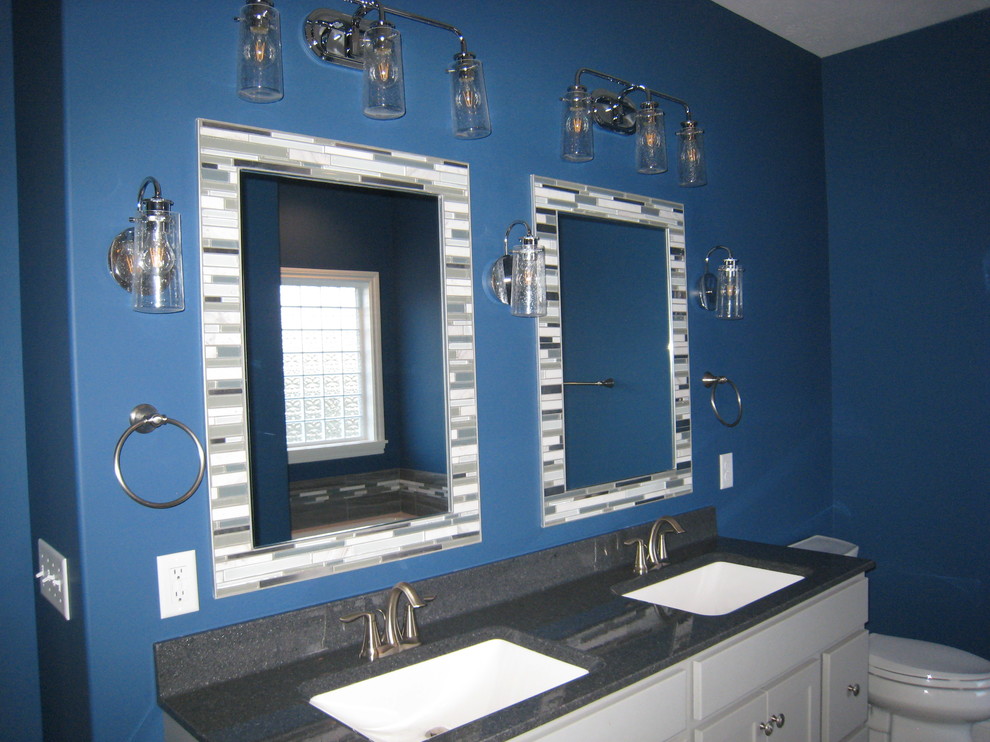 Photo of a medium sized contemporary ensuite bathroom in Chicago with beaded cabinets, white cabinets, a two-piece toilet, blue walls and a submerged sink.