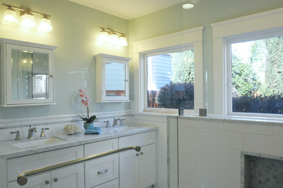Example of a mid-sized arts and crafts master white tile and ceramic tile marble floor double shower design in San Diego with an undermount sink, shaker cabinets, white cabinets, marble countertops, blue walls and a two-piece toilet