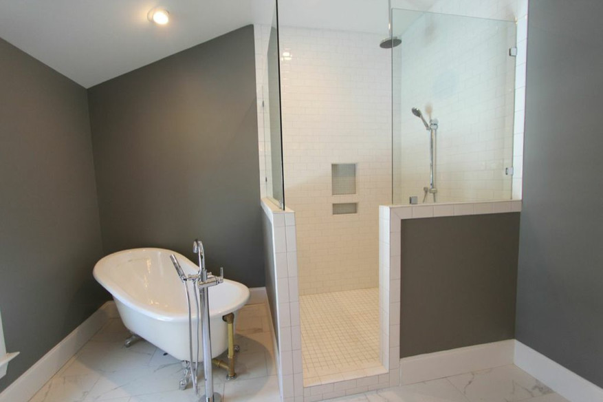 Exempel på ett stort modernt en-suite badrum, med ett nedsänkt handfat, luckor med infälld panel, vita skåp, marmorbänkskiva, ett badkar med tassar, en hörndusch, en toalettstol med hel cisternkåpa, vit kakel, stenkakel, grå väggar och marmorgolv