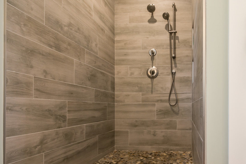 Design ideas for a medium sized rustic ensuite bathroom in Other with a freestanding bath, an alcove shower, beige tiles, ceramic tiles, grey walls, pebble tile flooring, brown floors and an open shower.