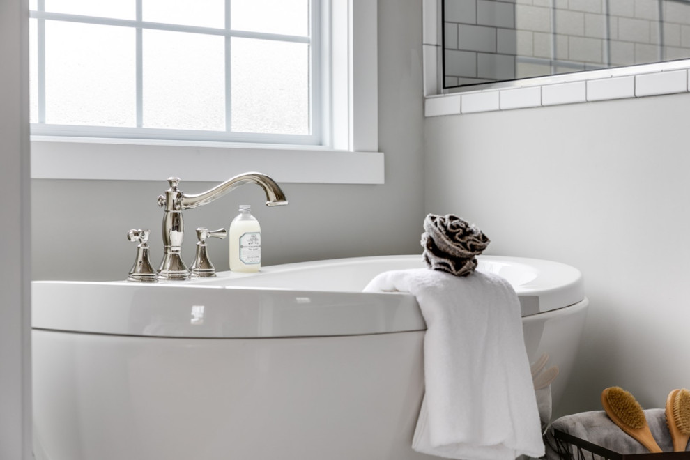 Пример оригинального дизайна: большая главная ванная комната в стиле кантри с отдельно стоящей ванной, угловым душем, белой плиткой, плиткой кабанчик, серыми стенами, полом из керамической плитки, белым полом и душем с распашными дверями