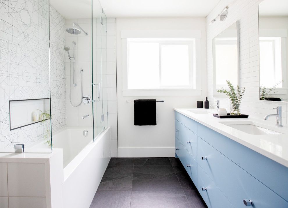 Bathroom - large transitional 3/4 white tile black floor and double-sink bathroom idea in Vancouver with flat-panel cabinets, blue cabinets, white walls, an undermount sink, a hinged shower door, white countertops, a niche and a floating vanity