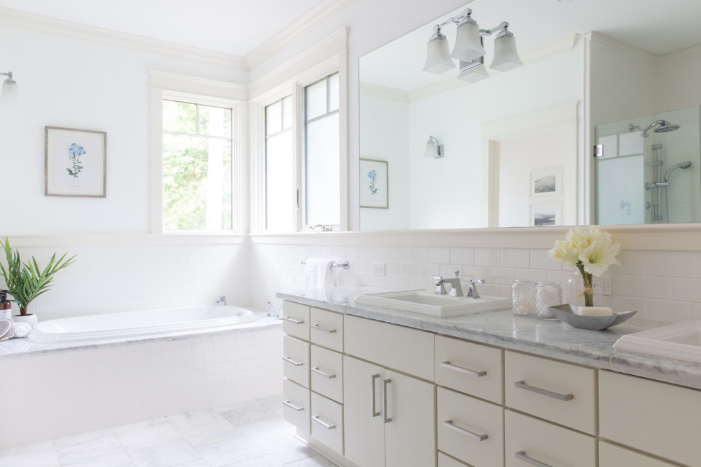 Inspiration for a transitional white tile and subway tile white floor and double-sink drop-in bathtub remodel in San Francisco with flat-panel cabinets, white cabinets, white walls, a drop-in sink, gray countertops and a built-in vanity