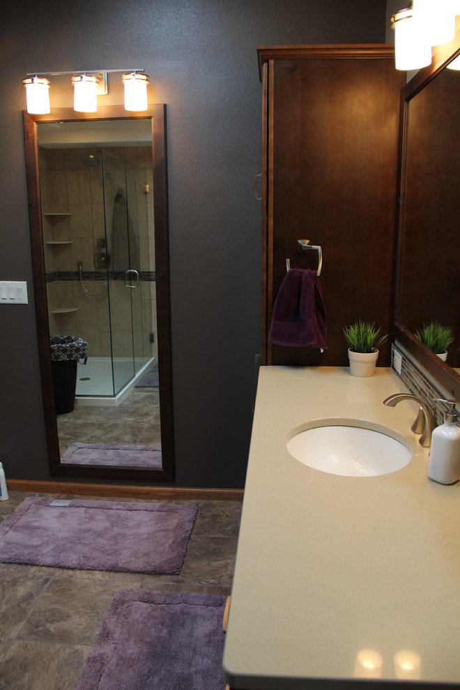 Cette photo montre une salle d'eau chic en bois foncé de taille moyenne avec un placard avec porte à panneau encastré, une douche d'angle, WC à poser, un carrelage multicolore, un lavabo encastré et un plan de toilette en surface solide.