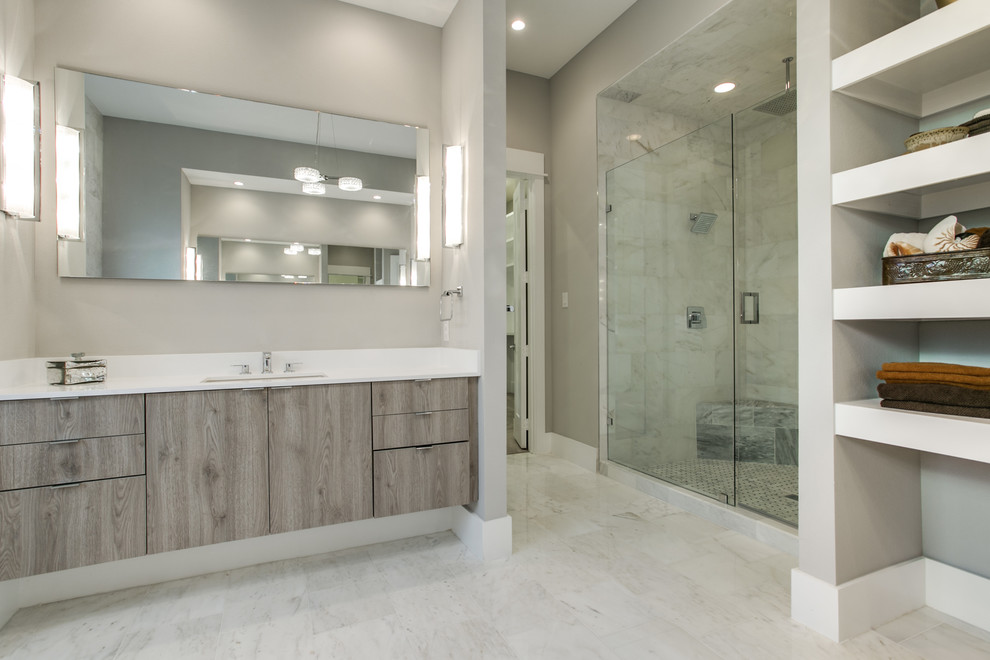 Design ideas for a large modern ensuite bathroom in Dallas with flat-panel cabinets, medium wood cabinets, a freestanding bath, an alcove shower, a one-piece toilet, beige tiles, ceramic tiles, beige walls, ceramic flooring, a submerged sink, engineered stone worktops, beige floors, a hinged door, white worktops, a shower bench, double sinks and a floating vanity unit.