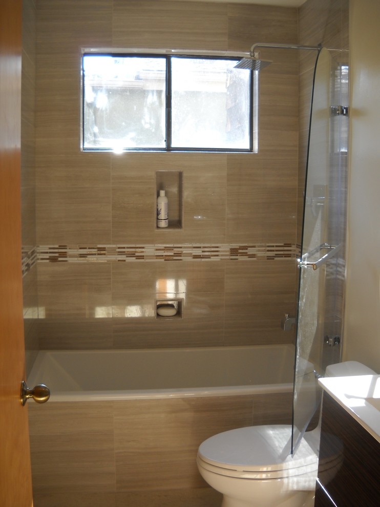 Medium sized contemporary ensuite bathroom in San Francisco with flat-panel cabinets, dark wood cabinets, a built-in bath, a shower/bath combination, a one-piece toilet, multi-coloured tiles, porcelain tiles, white walls, travertine flooring, a vessel sink, engineered stone worktops, beige floors and a hinged door.