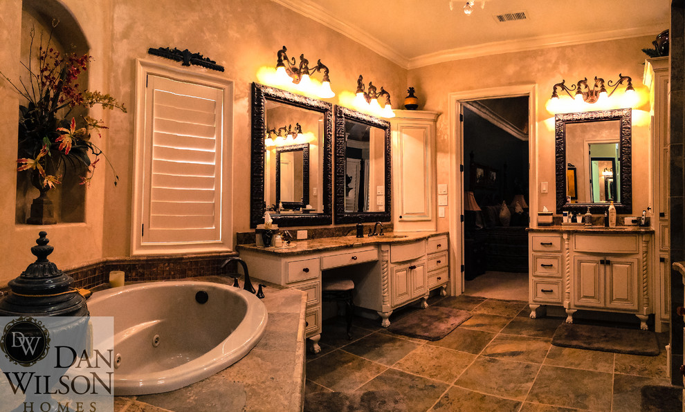 Large traditional ensuite bathroom in Austin with a submerged sink, freestanding cabinets, beige cabinets, granite worktops, a built-in bath, an alcove shower, a two-piece toilet, green tiles, ceramic tiles, beige walls and ceramic flooring.