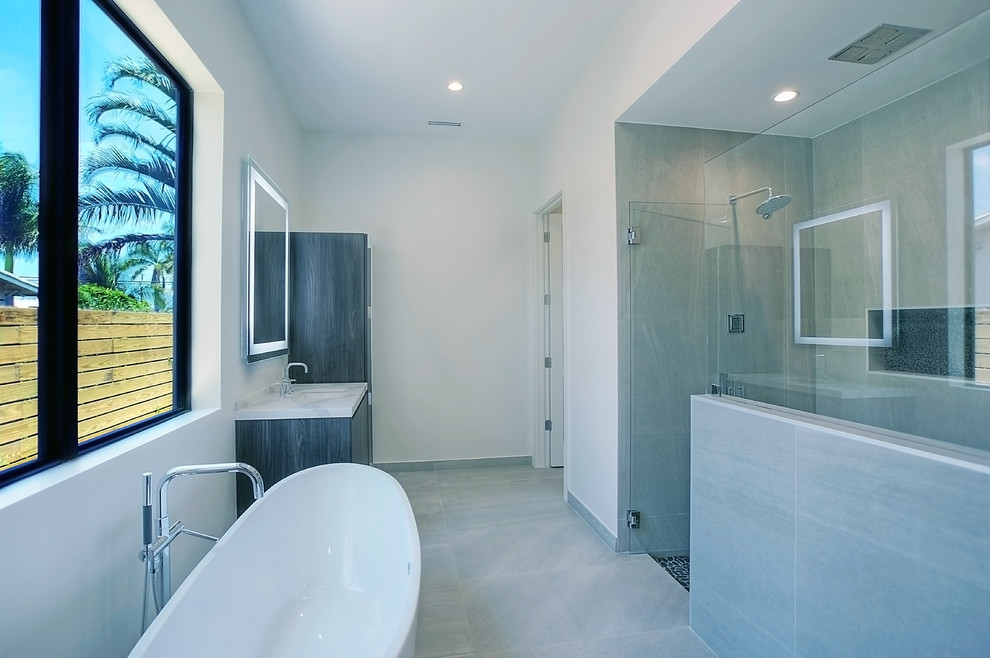 Bathroom - mid-sized contemporary master gray tile and porcelain tile porcelain tile and gray floor bathroom idea in Miami with flat-panel cabinets, a one-piece toilet, white walls, an undermount sink, concrete countertops, a hinged shower door and dark wood cabinets