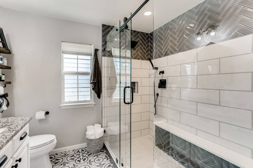 Mid-sized cottage master multicolored tile and subway tile cement tile floor, multicolored floor and double-sink bathroom photo in Denver with raised-panel cabinets, white cabinets, a built-in vanity, a two-piece toilet, gray walls, an undermount sink, quartz countertops, multicolored countertops and a niche