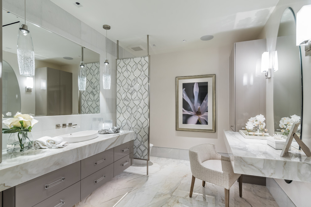 Coastal grey and cream ensuite bathroom in Miami with flat-panel cabinets, grey cabinets, beige walls, marble flooring, a vessel sink and marble worktops.