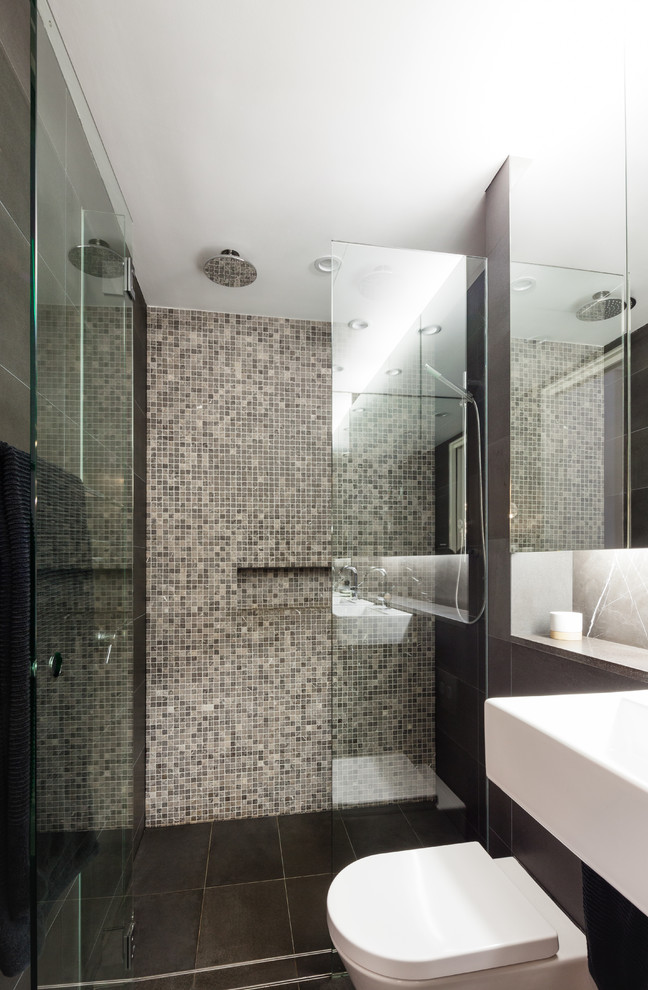 This is an example of a small shower room bathroom in Other with a wall-mounted sink, a walk-in shower, a wall mounted toilet, beige tiles, mosaic tiles, black walls and ceramic flooring.