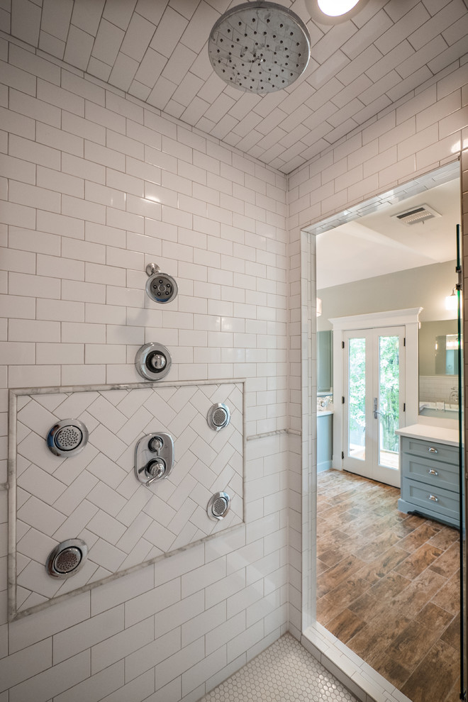 Photo of a large traditional ensuite bathroom in Houston with a submerged sink, shaker cabinets, white cabinets, quartz worktops, a claw-foot bath, a double shower, a two-piece toilet, white tiles, ceramic tiles, brown walls and porcelain flooring.