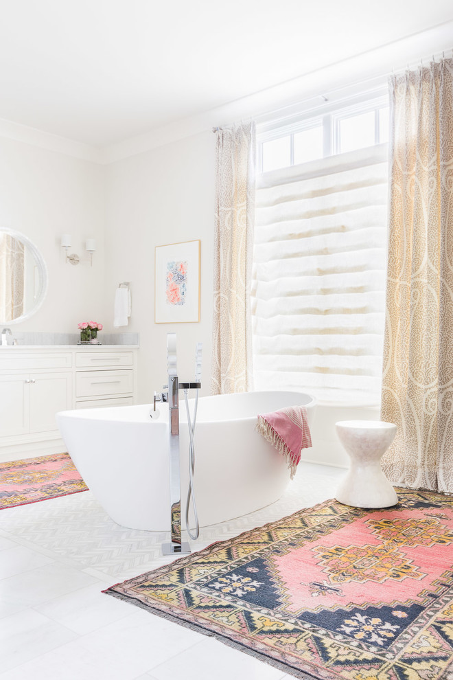 Modelo de cuarto de baño principal tradicional renovado con puertas de armario blancas, bañera exenta, paredes blancas y ventanas