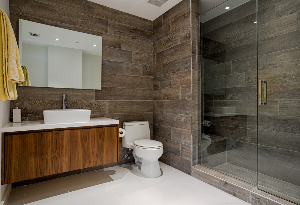 Inspiration for a contemporary alcove shower remodel in Miami with a vessel sink, flat-panel cabinets, dark wood cabinets and a one-piece toilet