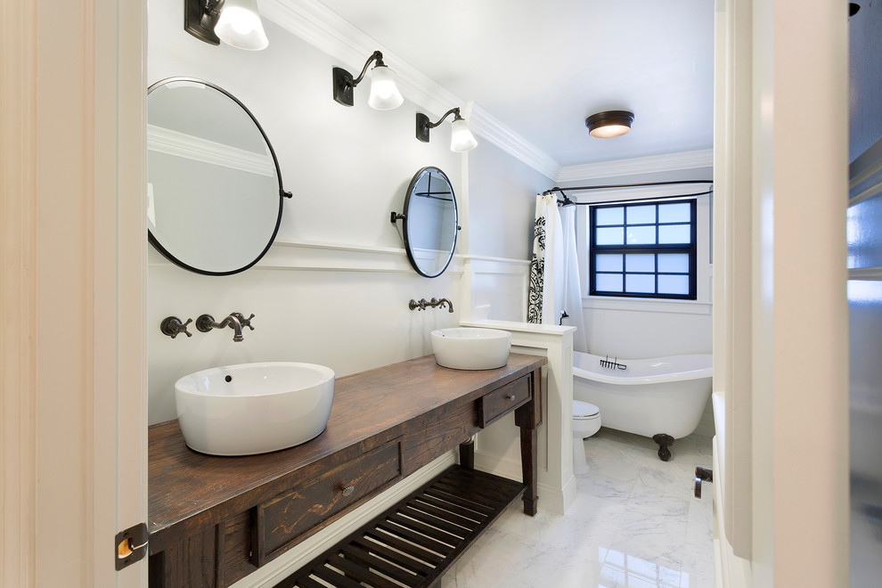 Bathroom - tropical kids' marble floor and multicolored floor bathroom idea in Other with furniture-like cabinets, dark wood cabinets, a one-piece toilet, white walls, a vessel sink, wood countertops and brown countertops