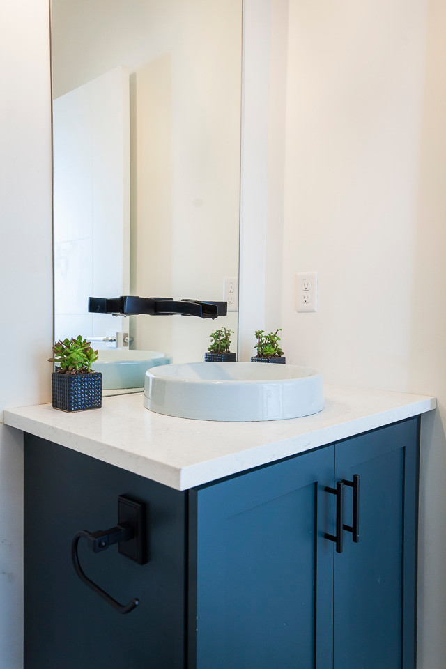 Medium sized traditional bathroom in Austin with shaker cabinets, blue cabinets, white walls, a built-in sink and engineered stone worktops.