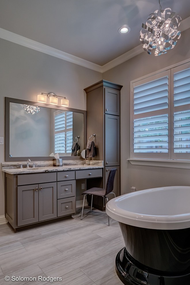 Inspiration for a large classic ensuite bathroom in New Orleans with shaker cabinets, grey cabinets, a freestanding bath, a double shower, grey walls, porcelain flooring, a submerged sink, granite worktops, grey floors and a hinged door.