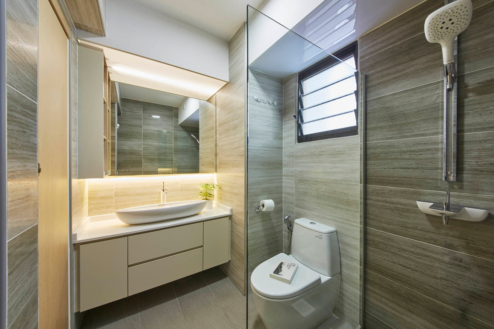 Design ideas for a medium sized contemporary ensuite bathroom in Singapore with flat-panel cabinets, beige cabinets, a walk-in shower, a one-piece toilet, beige tiles, ceramic tiles, beige walls, ceramic flooring, a built-in sink and solid surface worktops.