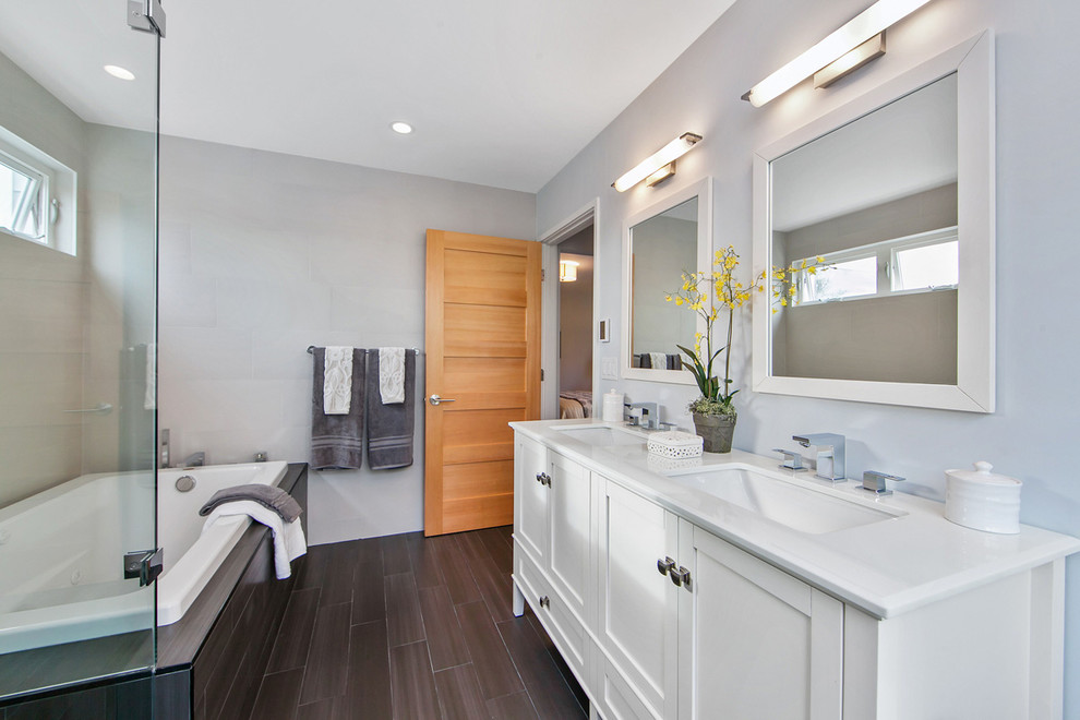 Photo of a medium sized contemporary ensuite bathroom in San Francisco with a submerged sink, shaker cabinets, white cabinets, marble worktops, a built-in bath, a double shower, a one-piece toilet, grey tiles, porcelain tiles, blue walls and porcelain flooring.