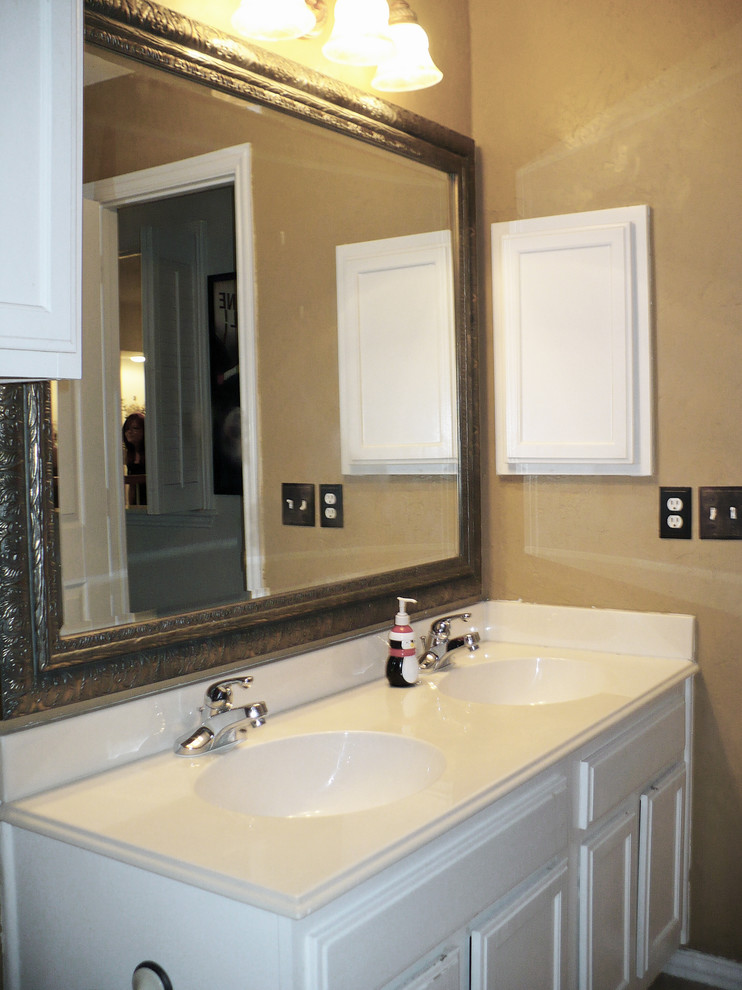 This is an example of a medium sized classic family bathroom in Dallas with an integrated sink, raised-panel cabinets, white cabinets, marble worktops, a shower/bath combination, a one-piece toilet, beige tiles, ceramic tiles, brown walls and ceramic flooring.