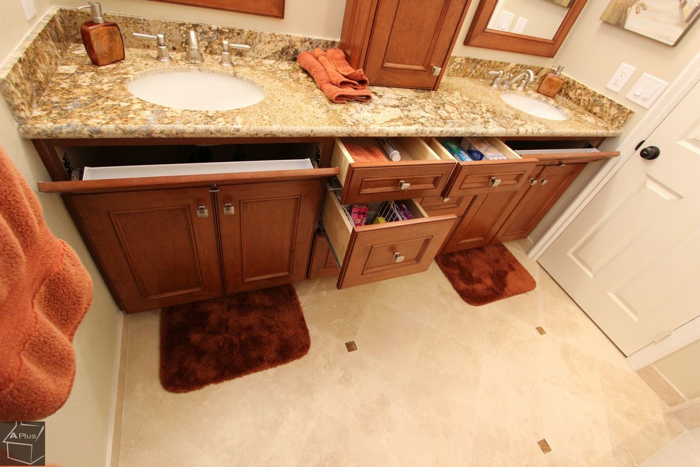 Example of a large classic master beige tile and porcelain tile porcelain tile bathroom design in Orange County with an undermount sink, recessed-panel cabinets, dark wood cabinets, granite countertops, a two-piece toilet and beige walls