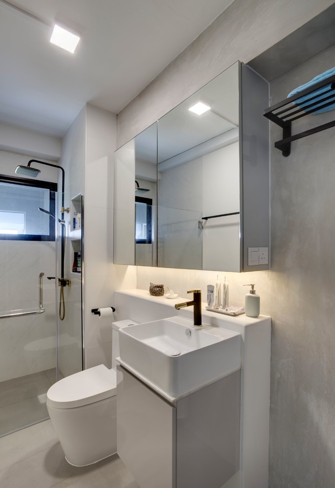Idées déco pour une salle de bain contemporaine avec un placard à porte plane, des portes de placard grises, WC à poser, un carrelage gris, un mur gris, un plan vasque, un sol gris et aucune cabine.
