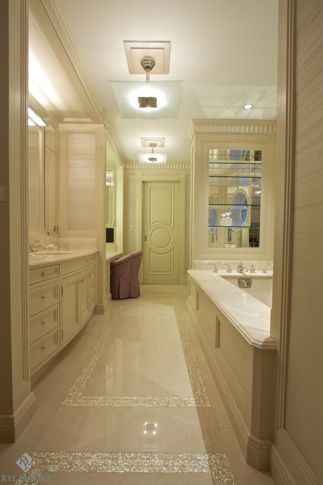 Example of a classic bathroom design in New York with marble countertops