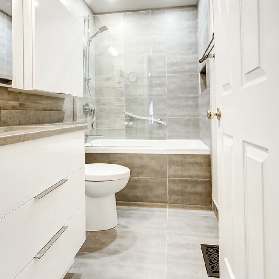 Bathroom - small contemporary 3/4 brown tile and porcelain tile porcelain tile and gray floor bathroom idea in Ottawa with flat-panel cabinets, white cabinets, a two-piece toilet, beige walls, an undermount sink, quartz countertops and gray countertops