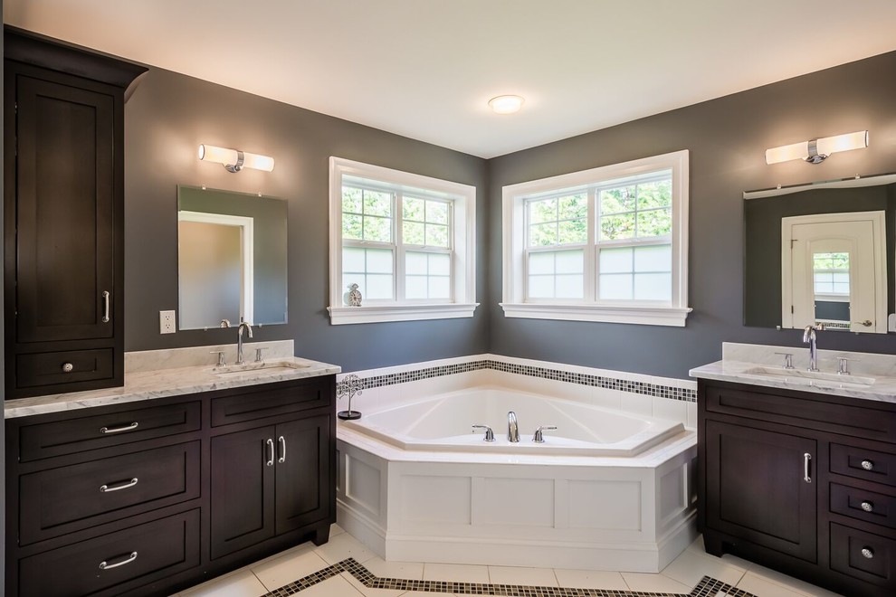 Design ideas for a large traditional ensuite bathroom in Philadelphia with shaker cabinets, dark wood cabinets, a built-in bath, an alcove shower, white tiles, grey walls, ceramic flooring, a submerged sink, granite worktops, white floors and a sliding door.