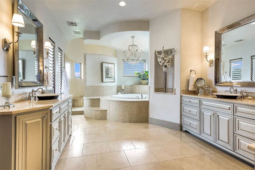Huge trendy master beige tile and ceramic tile ceramic tile and beige floor bathroom photo in Austin with raised-panel cabinets, beige cabinets, white walls, a drop-in sink and granite countertops