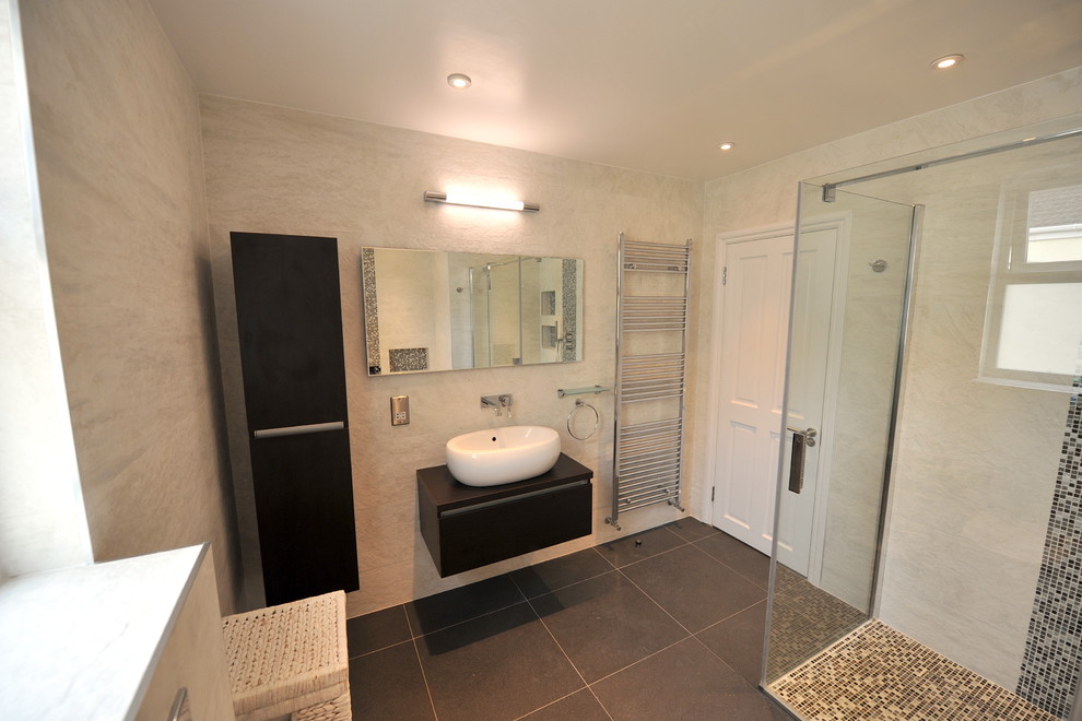Cette photo montre une salle de bain tendance de taille moyenne avec un lavabo suspendu, un placard à porte plane, des portes de placard marrons, une douche ouverte, WC suspendus, un carrelage blanc, un carrelage de pierre et un sol en carrelage de céramique.