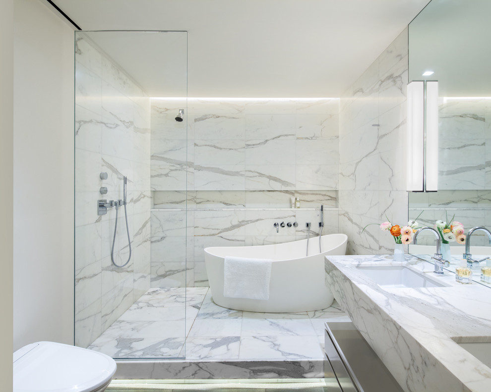 Inspiration for a contemporary ensuite bathroom in New York with flat-panel cabinets, grey cabinets, a freestanding bath, a walk-in shower, white walls, a submerged sink and an open shower.