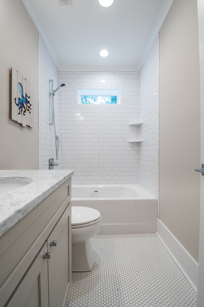 Design ideas for a medium sized traditional shower room bathroom in Charleston with shaker cabinets, grey cabinets, an alcove bath, a shower/bath combination, a one-piece toilet, white tiles, metro tiles, grey walls, mosaic tile flooring, a submerged sink and granite worktops.