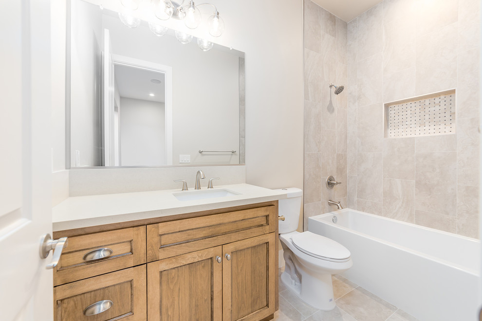 Inspiration for a small contemporary 3/4 beige tile and ceramic tile ceramic tile and beige floor bathroom remodel in Sacramento with beaded inset cabinets, medium tone wood cabinets, a two-piece toilet, beige walls, an integrated sink, solid surface countertops, a hinged shower door and beige countertops