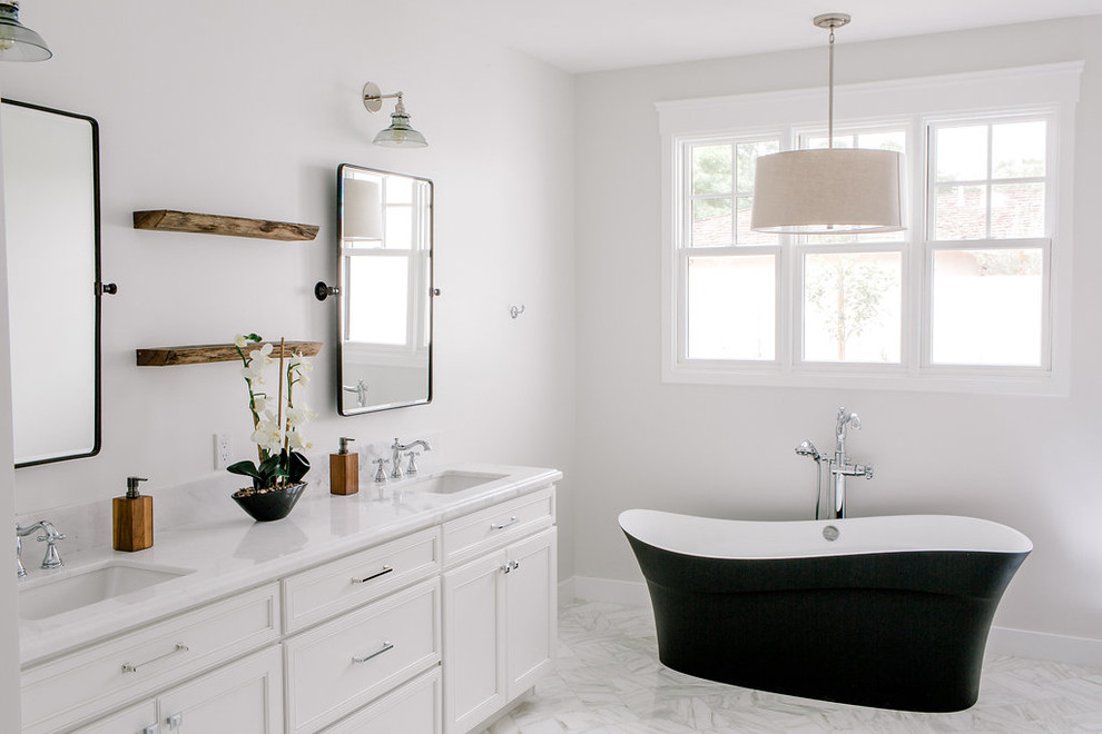 Example of a farmhouse master gray tile and subway tile marble floor freestanding bathtub design in Phoenix with a one-piece toilet, gray walls, an undermount sink and marble countertops