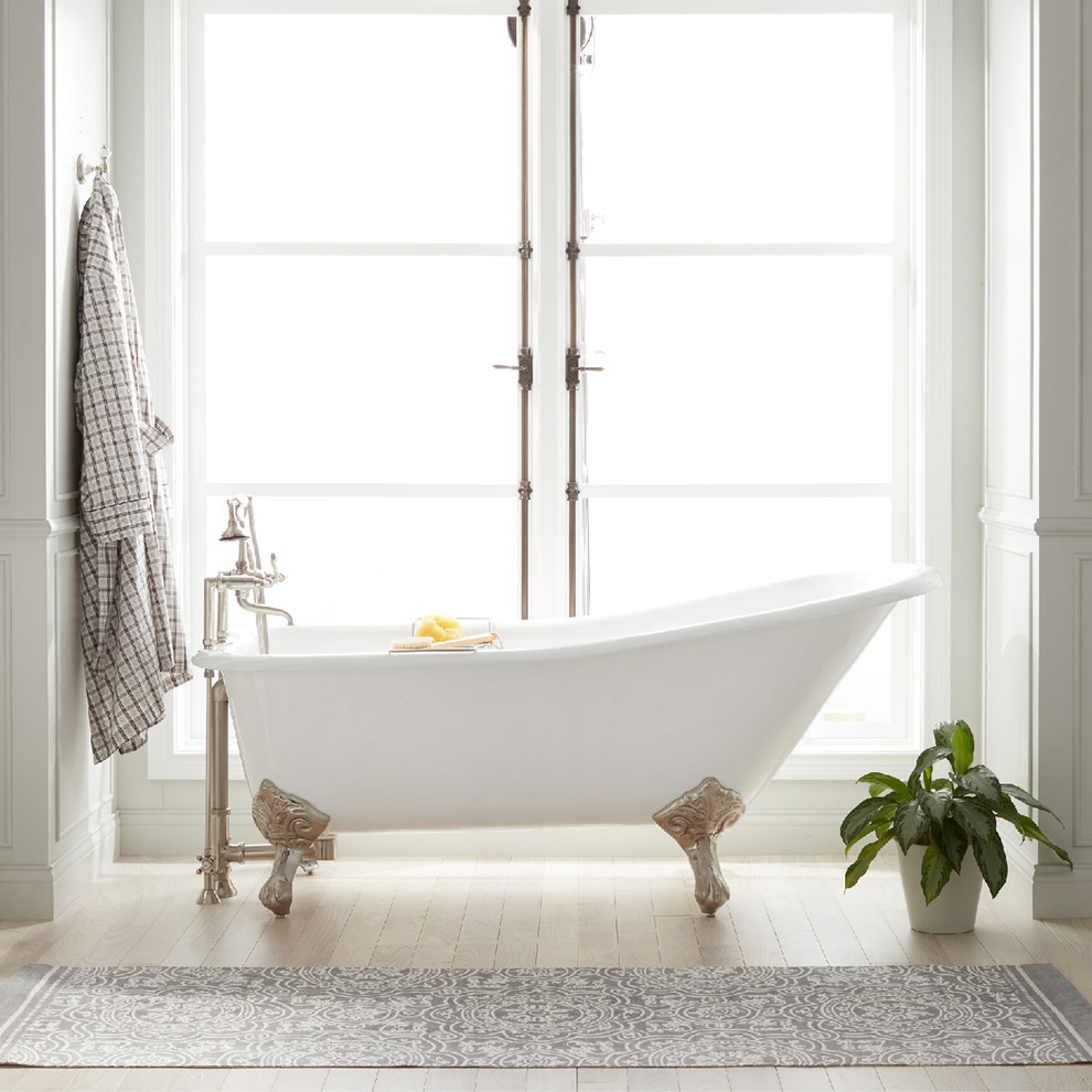 Immagine di una stanza da bagno country con ante bianche, vasca con piedi a zampa di leone, top in granito e top nero
