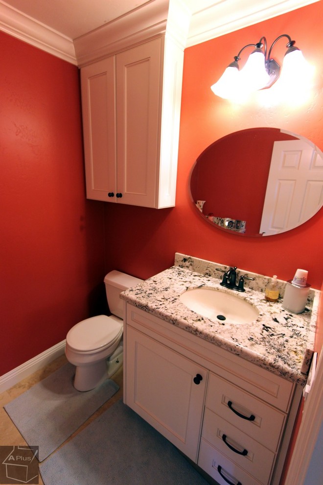 Bathroom - small traditional 3/4 porcelain tile bathroom idea in Orange County with an undermount sink, recessed-panel cabinets, white cabinets, granite countertops, a two-piece toilet and red walls