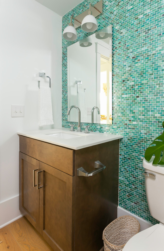 Photo of a large world-inspired ensuite bathroom in Charleston with shaker cabinets, grey cabinets, an alcove shower, a two-piece toilet, white tiles, metro tiles, white walls, porcelain flooring, an integrated sink, engineered stone worktops, blue floors, a hinged door and white worktops.
