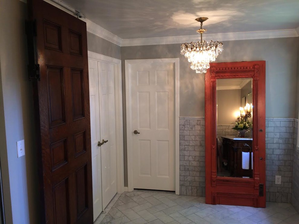 Photo of a medium sized victorian ensuite bathroom in Indianapolis with recessed-panel cabinets, dark wood cabinets, grey tiles, metro tiles, grey walls, porcelain flooring, a submerged sink, marble worktops and a corner shower.