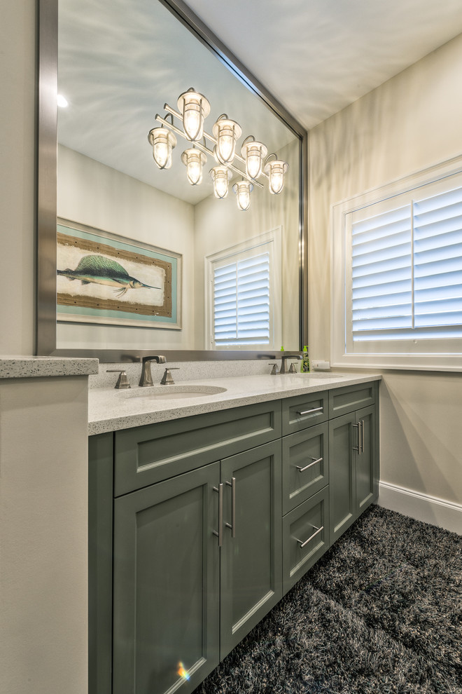 Mid-sized kids' multicolored tile medium tone wood floor and brown floor bathroom photo in Miami with recessed-panel cabinets, green cabinets, multicolored walls, an undermount sink and granite countertops