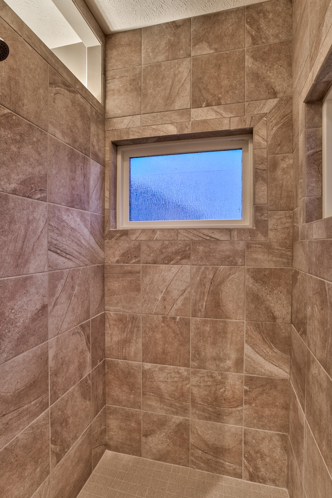 Doorless shower - mid-sized mediterranean master gray tile and ceramic tile ceramic tile doorless shower idea in Omaha with an undermount sink, recessed-panel cabinets, medium tone wood cabinets, granite countertops and gray walls