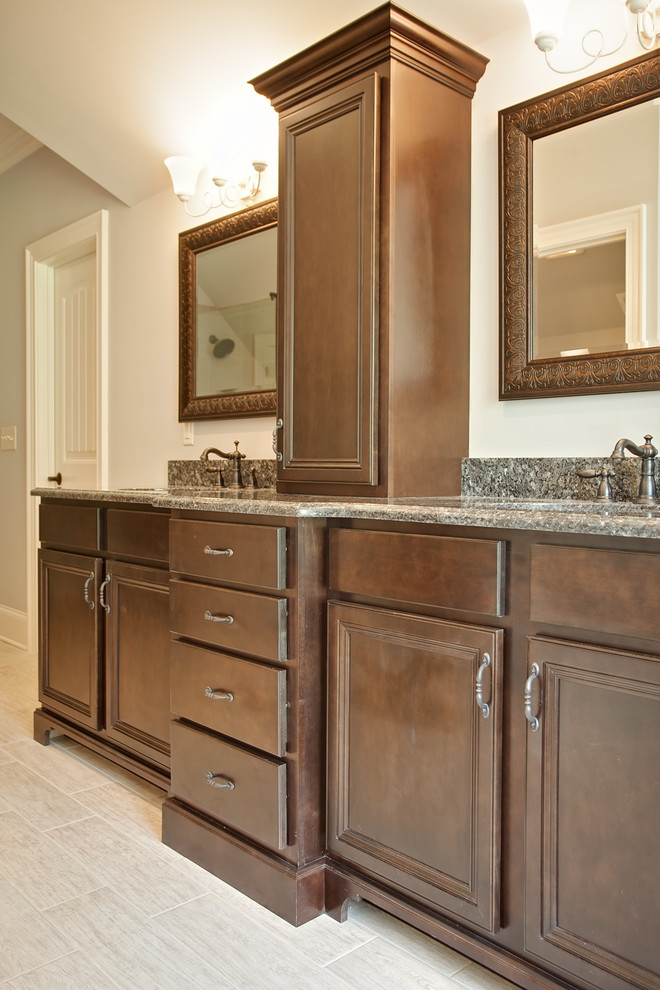Example of a large transitional master bathroom design in Other with an undermount sink, brown cabinets and granite countertops