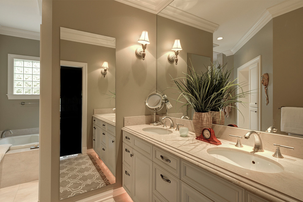 Photo of a large traditional ensuite bathroom in Seattle with a submerged sink, recessed-panel cabinets, white cabinets, tiled worktops, a built-in bath, white tiles, ceramic tiles, beige walls and ceramic flooring.