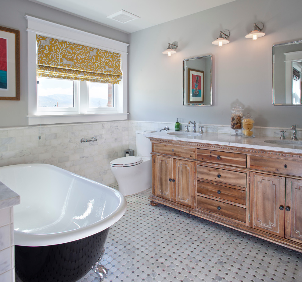 Example of a classic claw-foot bathtub design in Denver with recessed-panel cabinets