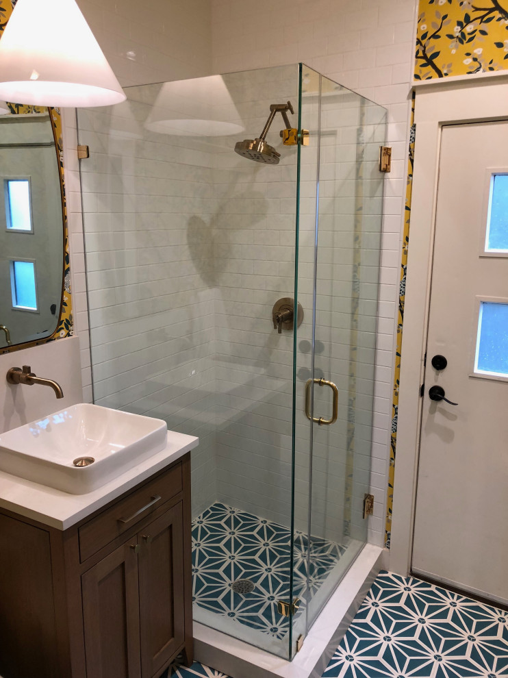 Inspiration for an eclectic master white tile and subway tile ceramic tile and blue floor corner shower remodel in Austin with shaker cabinets, dark wood cabinets, a vessel sink, solid surface countertops, a hinged shower door and white countertops
