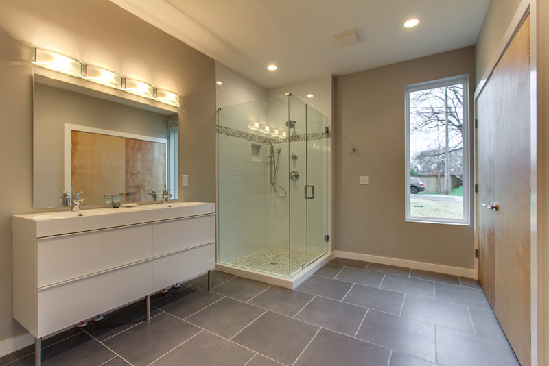 Corner shower - mid-sized modern master gray tile and ceramic tile ceramic tile corner shower idea in Nashville with an integrated sink, furniture-like cabinets, white cabinets and gray walls