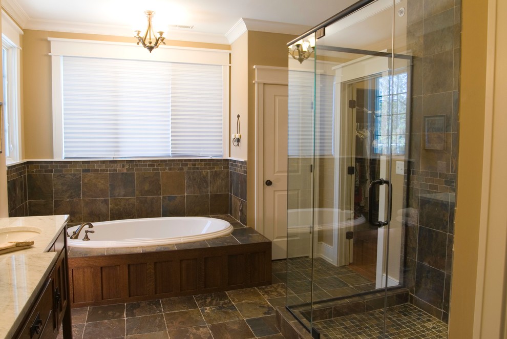 Large arts and crafts multicolored tile and stone tile slate floor bathroom photo in Chicago with an undermount sink, flat-panel cabinets, medium tone wood cabinets, marble countertops, a two-piece toilet and beige walls