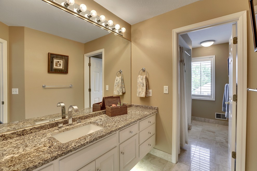 Example of a large classic kids' brown tile and stone tile bathroom design in Minneapolis with an undermount sink, raised-panel cabinets, white cabinets, granite countertops, a two-piece toilet and brown walls