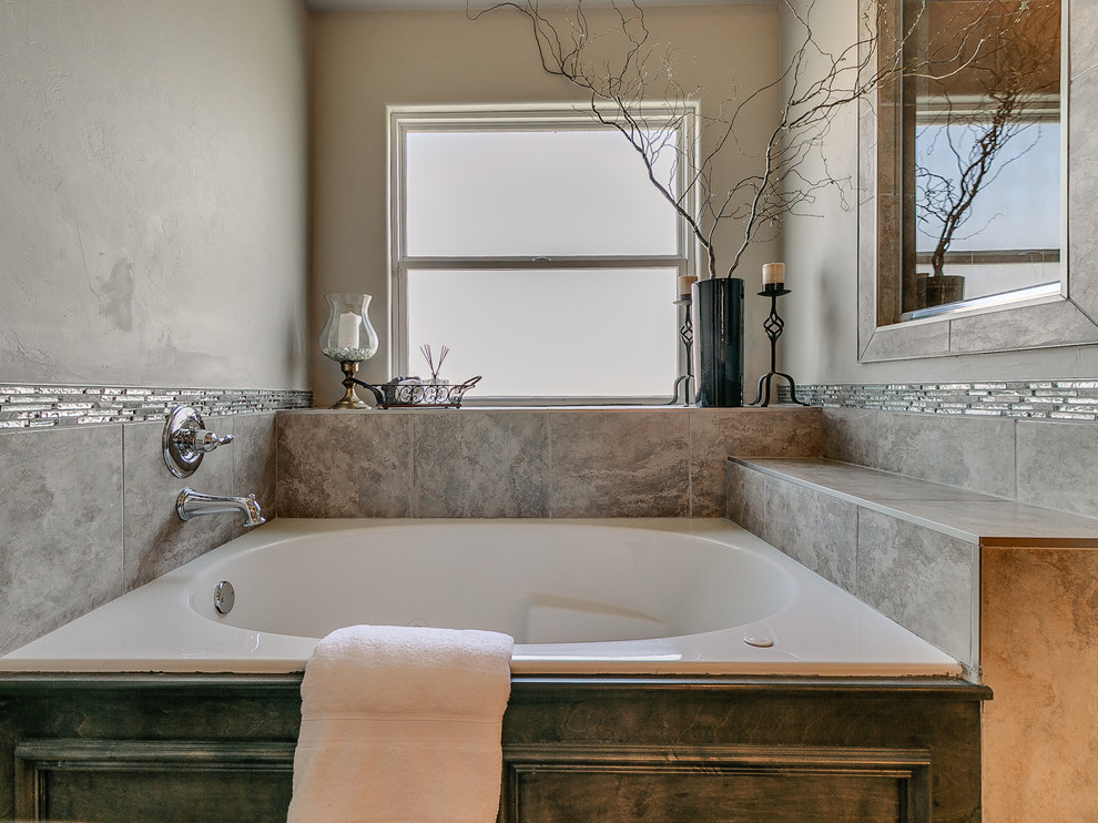 This is an example of a large traditional ensuite bathroom in Oklahoma City with raised-panel cabinets, distressed cabinets, a built-in bath, an alcove shower, a two-piece toilet, beige walls, ceramic flooring and a submerged sink.